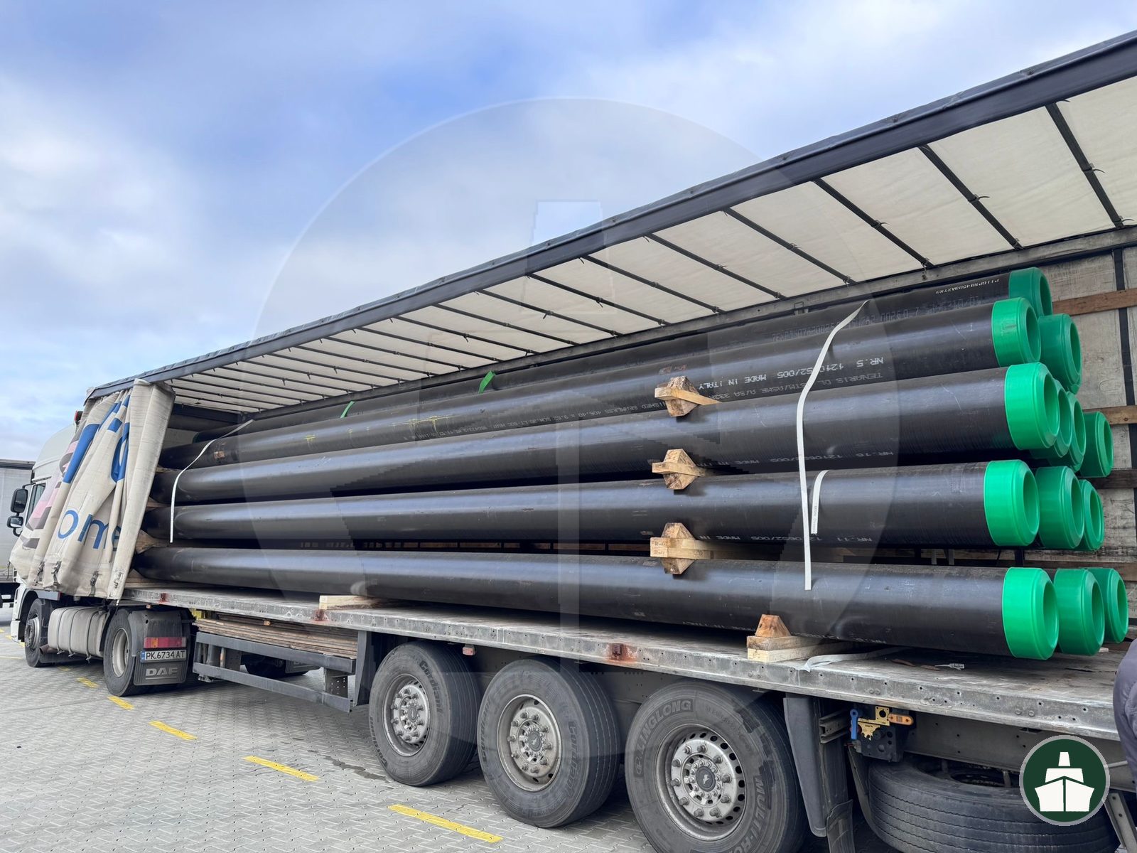 Industrial pipe cargo loaded on a trailer for road transport to Central Asia